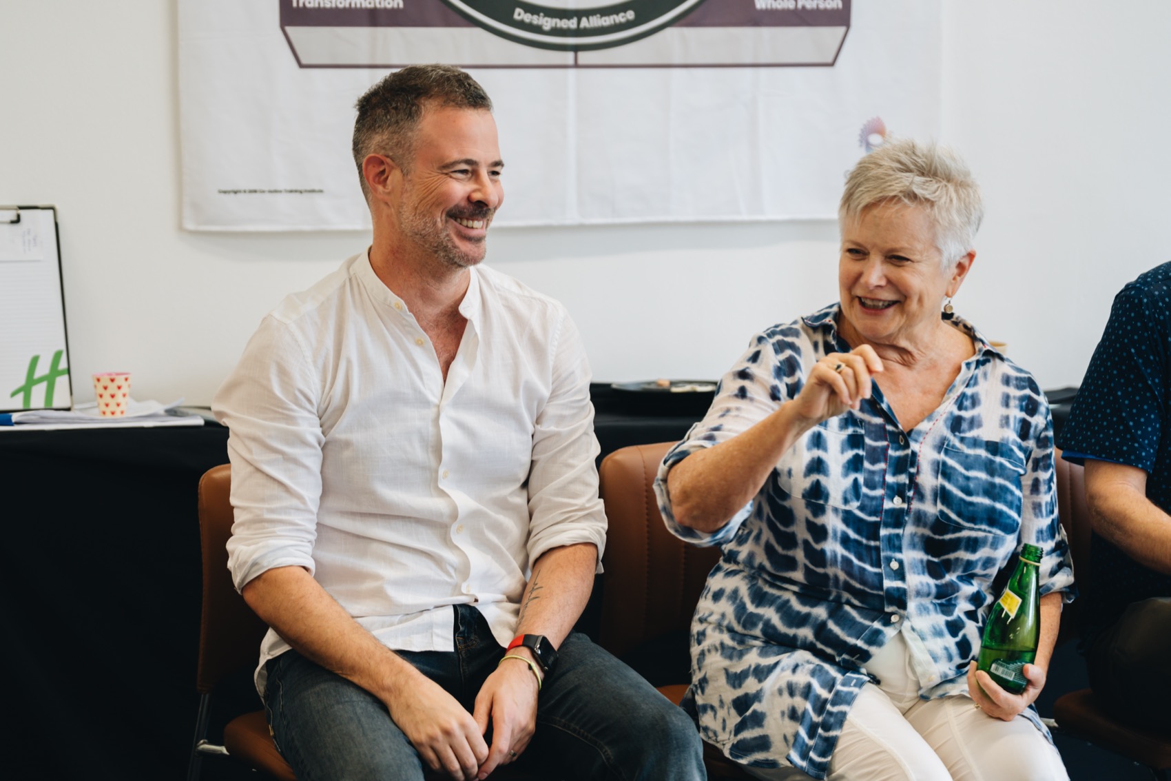 Two participants laughing together in session