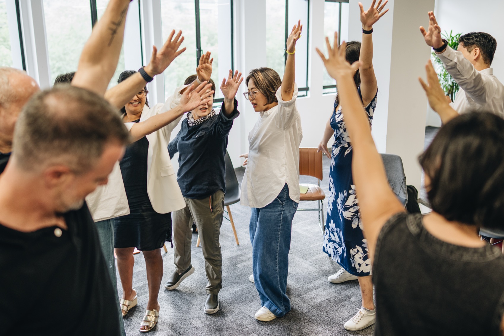 The whole cohort with arms raised in a group exercise