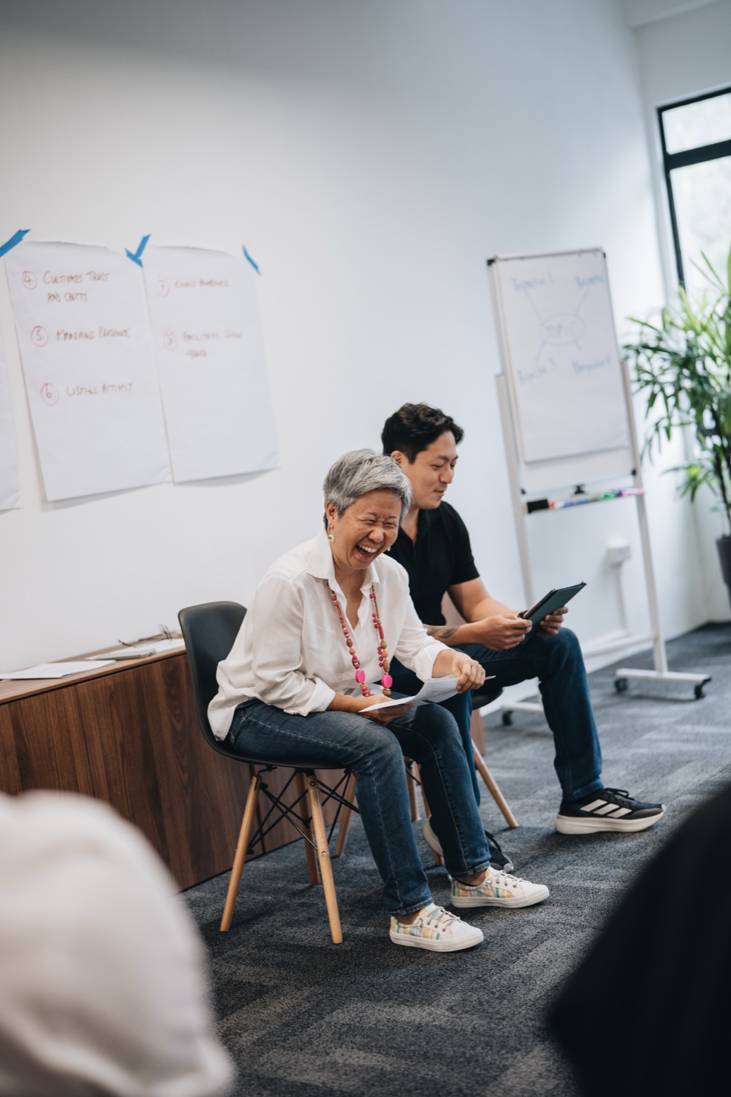 Two participants sharing a laugh during training