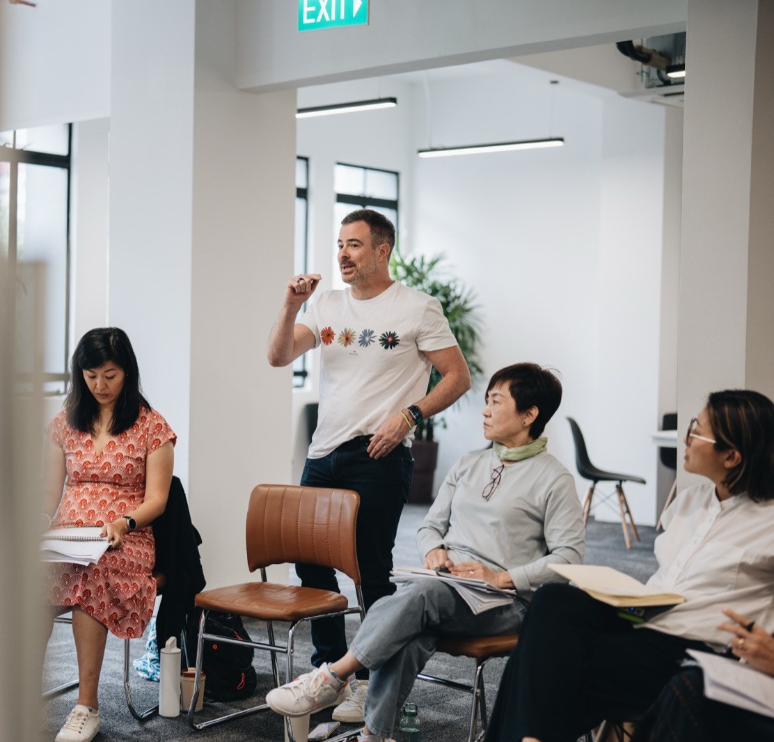 A participant speaking to the group during live practice